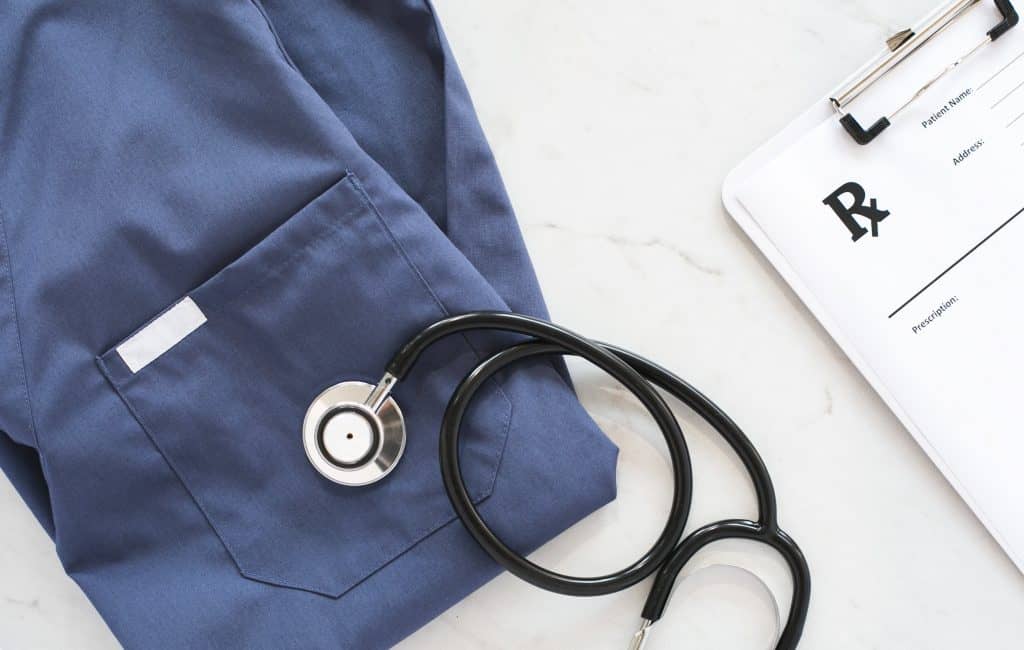stethoscope and a blue scrub suit