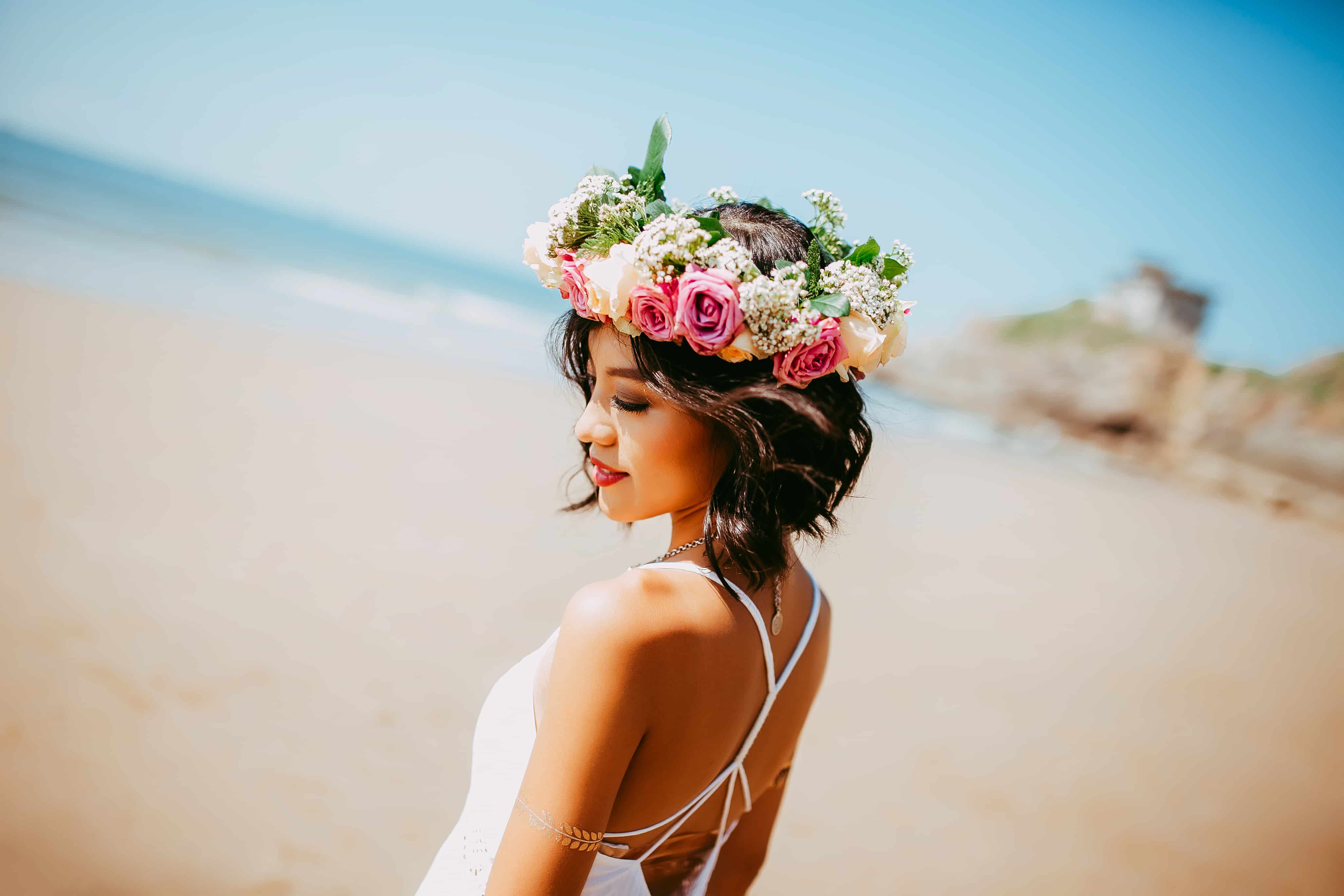 woman wearing flower crown on the beach