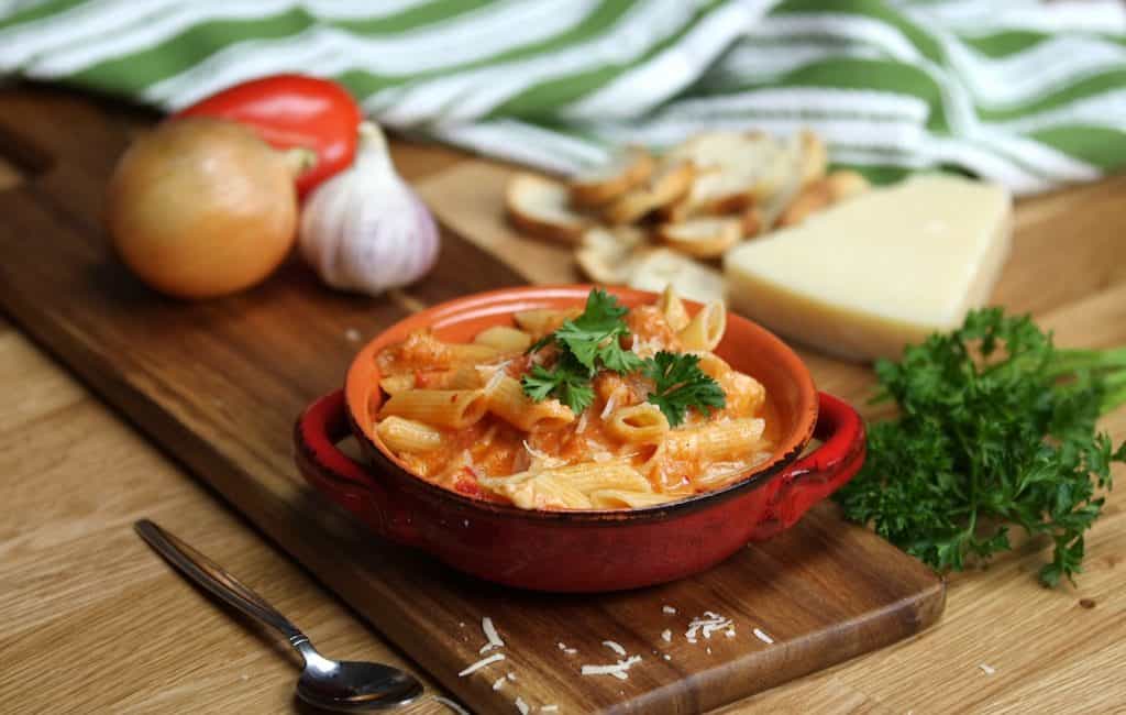 a pasta on a red bowl