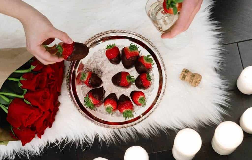 putting fresh strawberry onto a cake