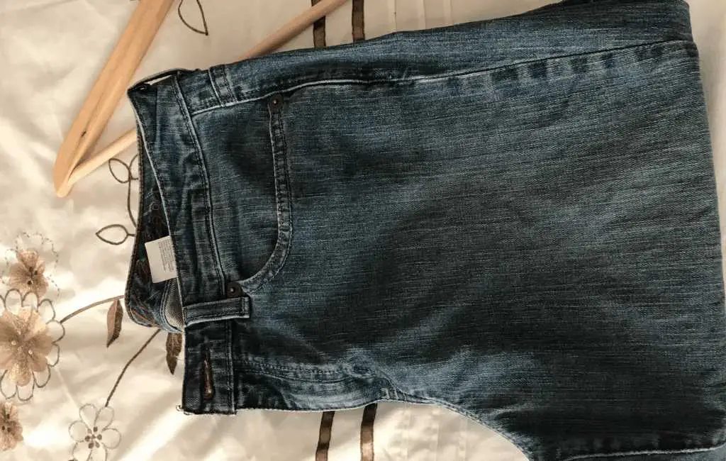 denim pants on a bed