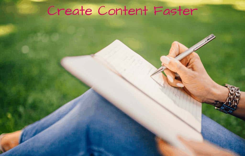 woman writing on her notebook while sitting on a grass