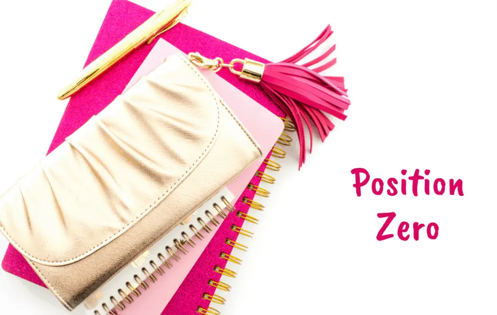 purse with pink tassel on a pink notebook