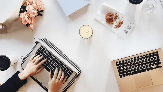 two laptops on a white desk