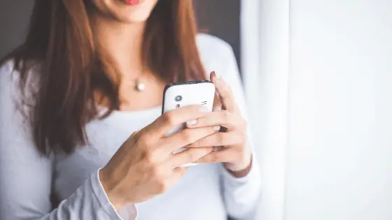 woman holding a phone with her two hands
