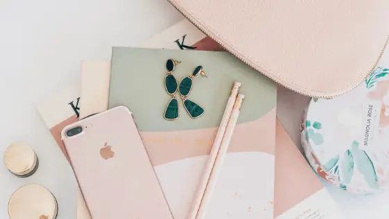 a photo of an iphone and a pencil on a notebook