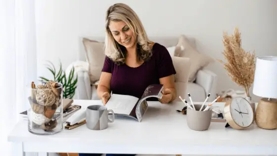 sitting woman flipping pages of a magazine