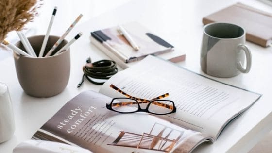 open magazine with eye glasses on it