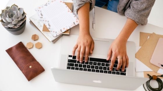 a photo of a hand typing in a keyboard