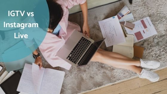 a woman sitting on a carpet holding her laptop while flipping pages of her notes