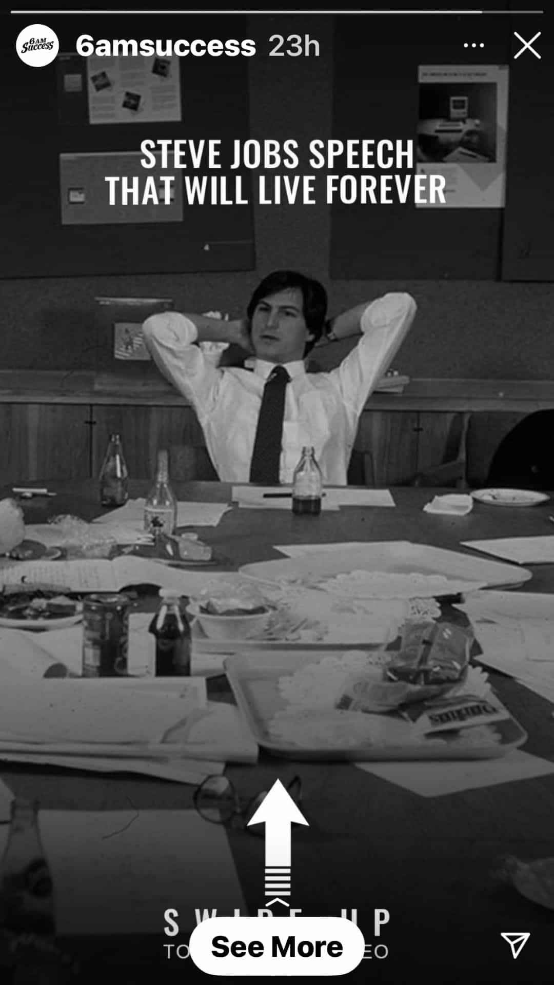 a black and white photo with a corporate man sitting on a conference table while hands on back neck