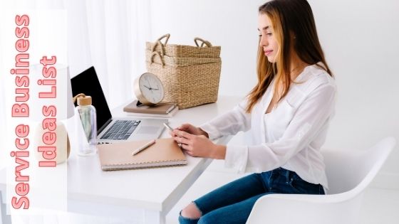 woman sitting on her working space while using her phone