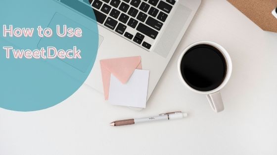 photo of a laptop with a card and pen next to a cup of hot beverage