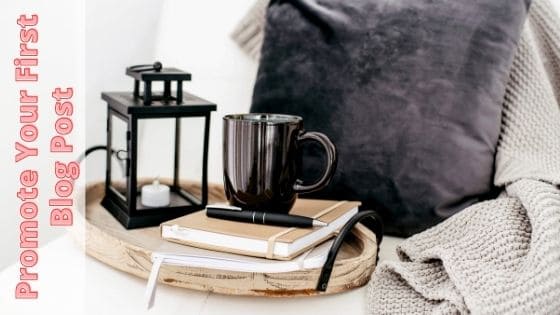 photo of coffee cup on notebook and a lamp on breakfast tray