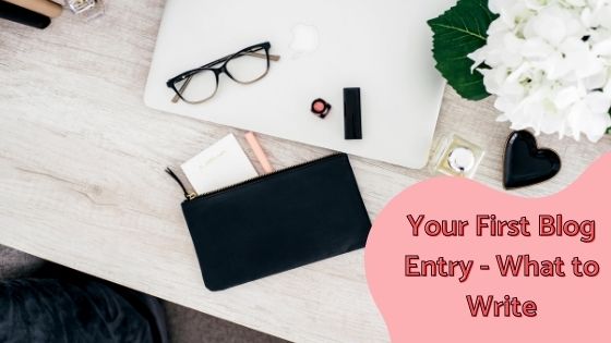 photo of closed laptop on desk with glasses, lipstick and ladies purse