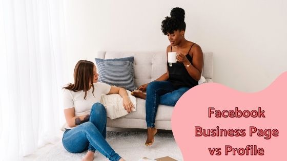 photo of two women sitting near a sofa chatting