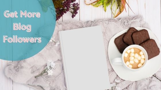 photo of a notebook next to a plate with chocolate biscuits and hot chocolate