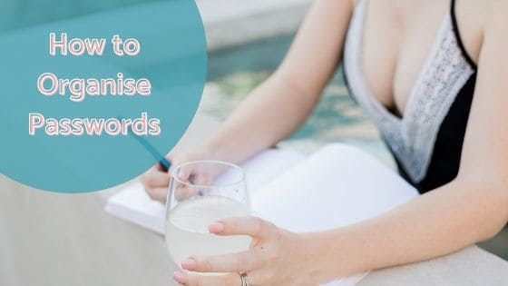woman writing on a notebook while holding a drink