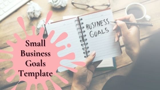 woman writing business goals on a small notebook