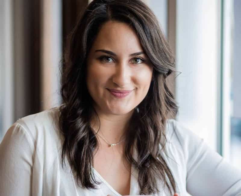 A woman named Alessandra Pollina holding a coffee mug