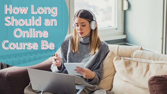 photo of a woman sitting on a sofa with a blanket on her lap with headphones on, a laptop on her lap, a notepad in one hand and a pen in the other