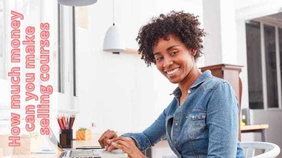 photo of a woman sitting at a laptop while typing and looking away from the screen to her left