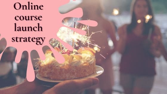 a photo of a cake with celebratory sparklers and people in the background celebrating a course launch