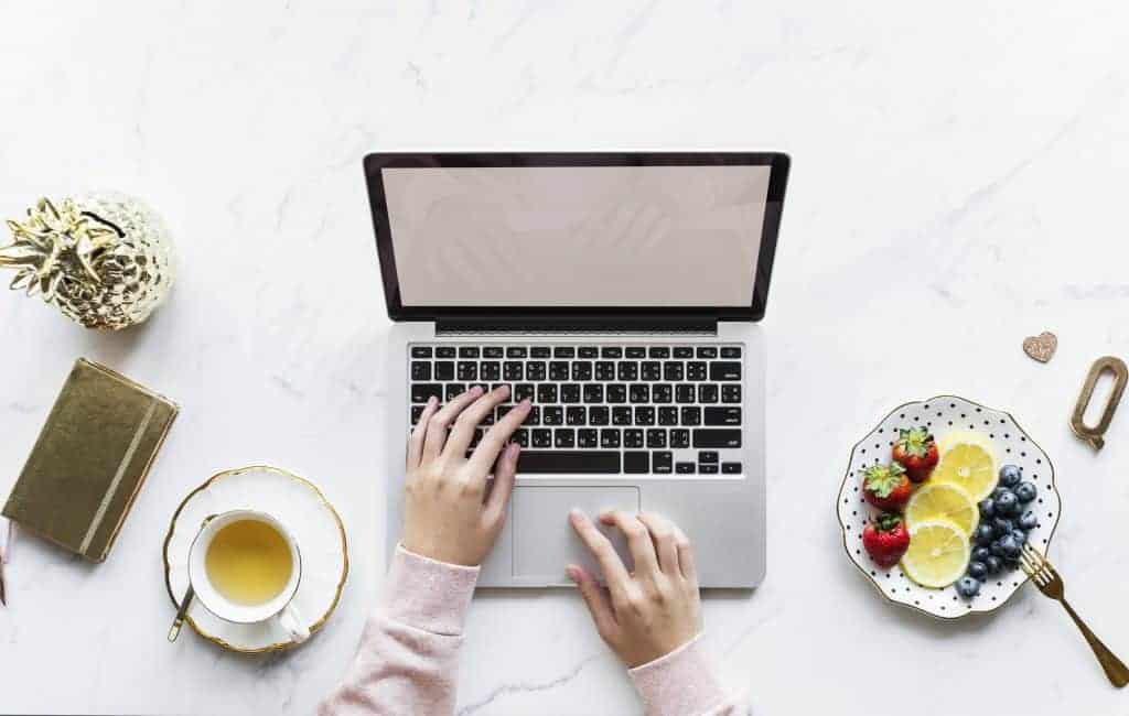 laptop at the table with tea at side