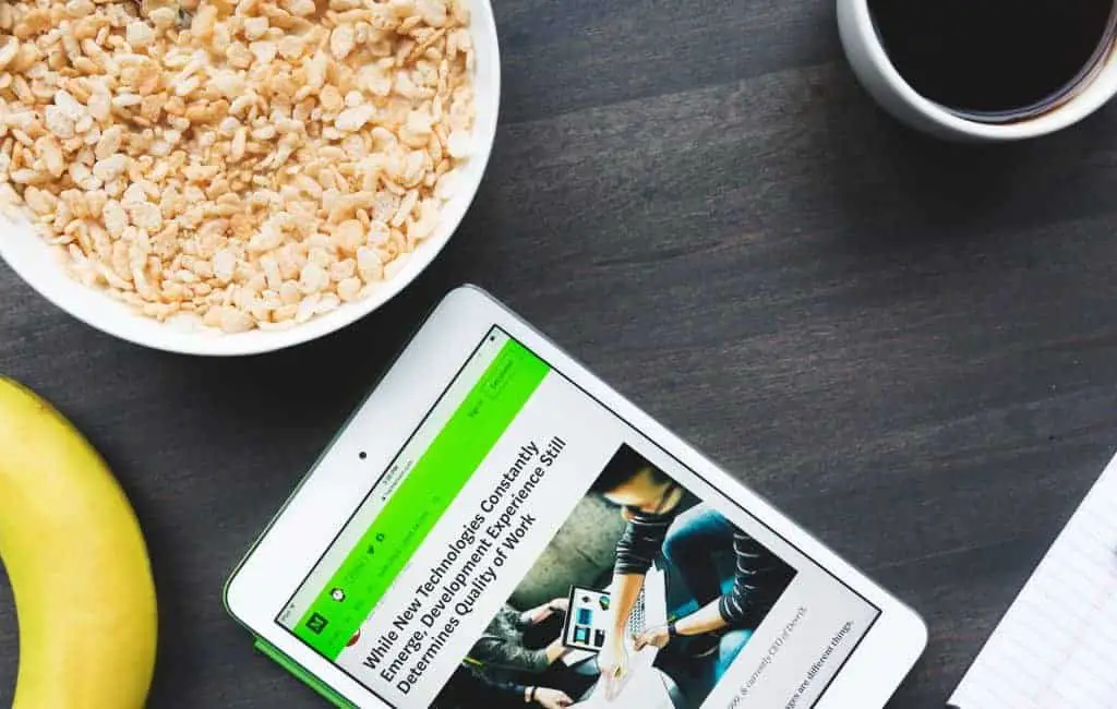 tablet next to a bowl of breakfast