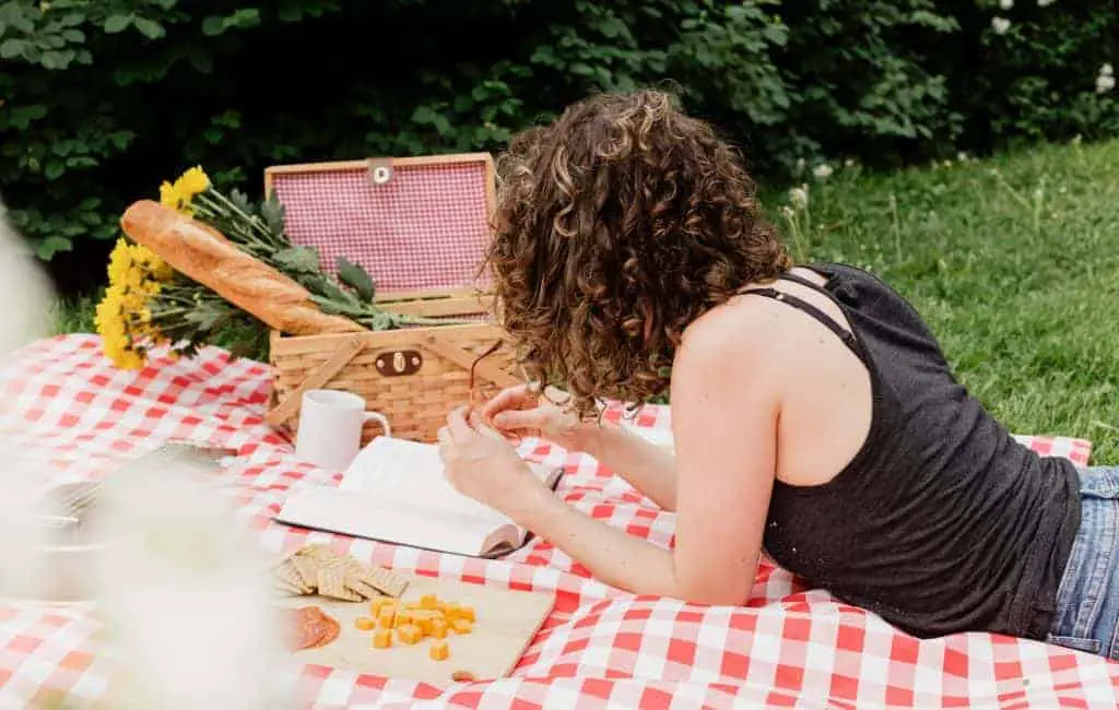 woman reading on a picnic blanket