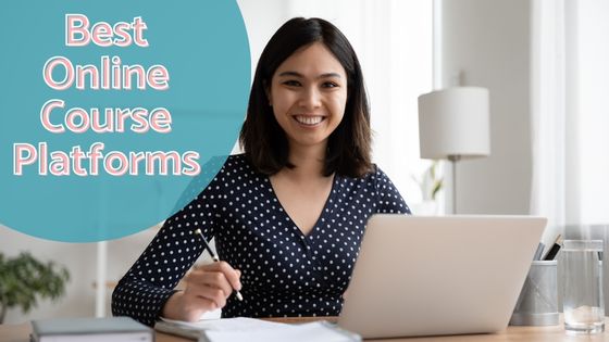 photo of a woman sitting in front of a laptop with a pen in her hand and notebook beside the laptop