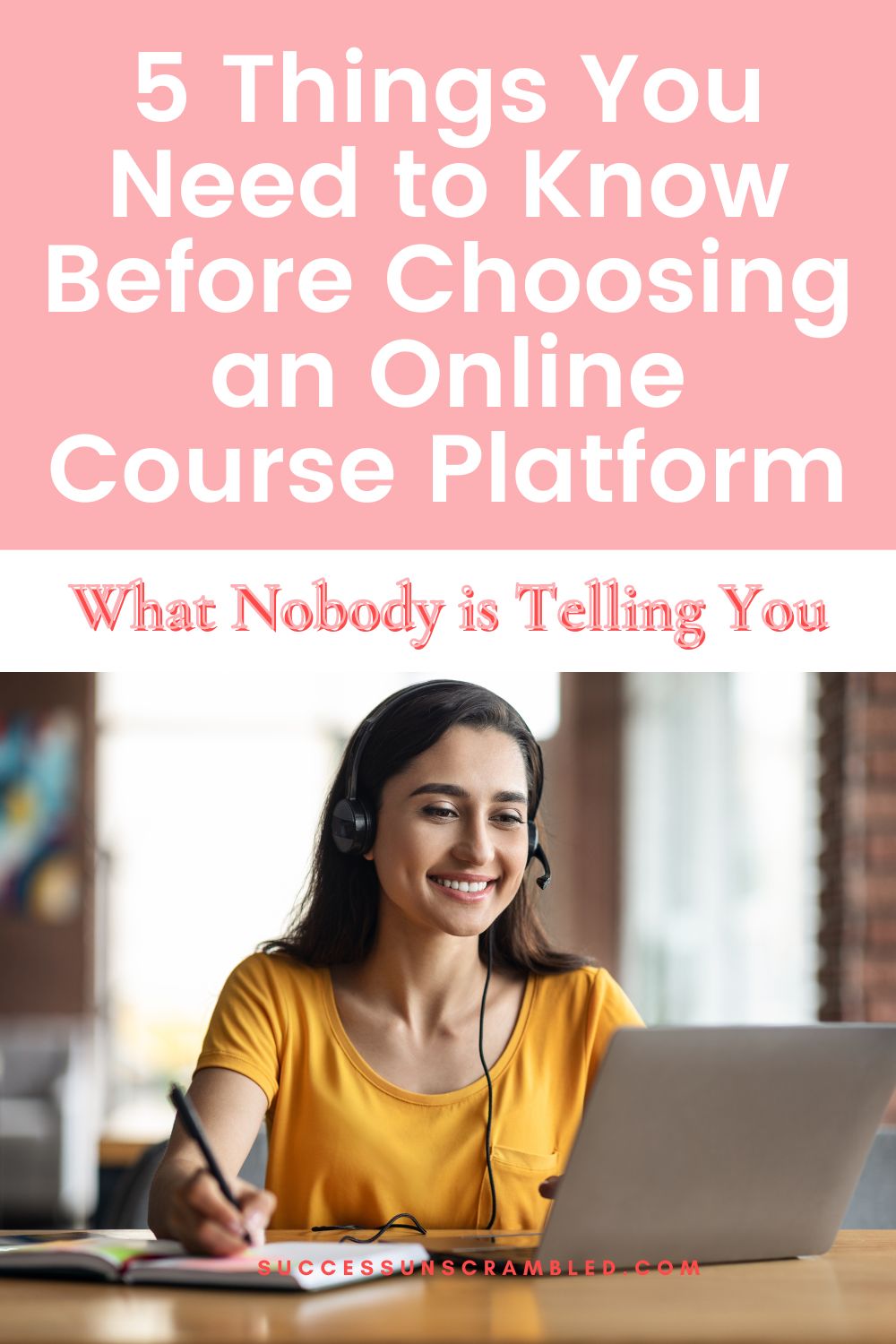 photo of a woman sitting in front of a laptop smiling and taking notes in a book on the table.