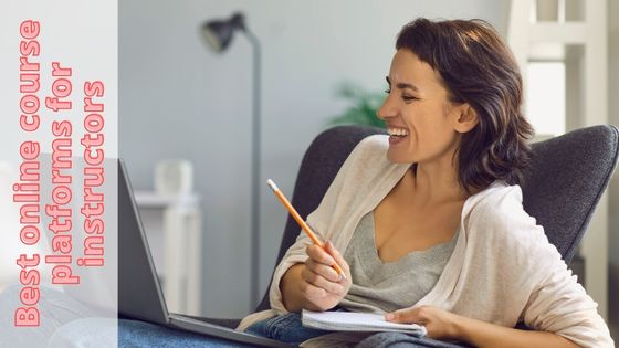 photo of a woman sitting with a laptop on her lap and she is smiling with a pencil in one hand and a notebook in the other