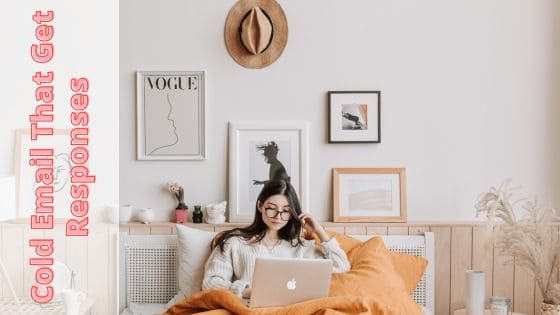 photo of a woman sitting in bed doing work on her laptop